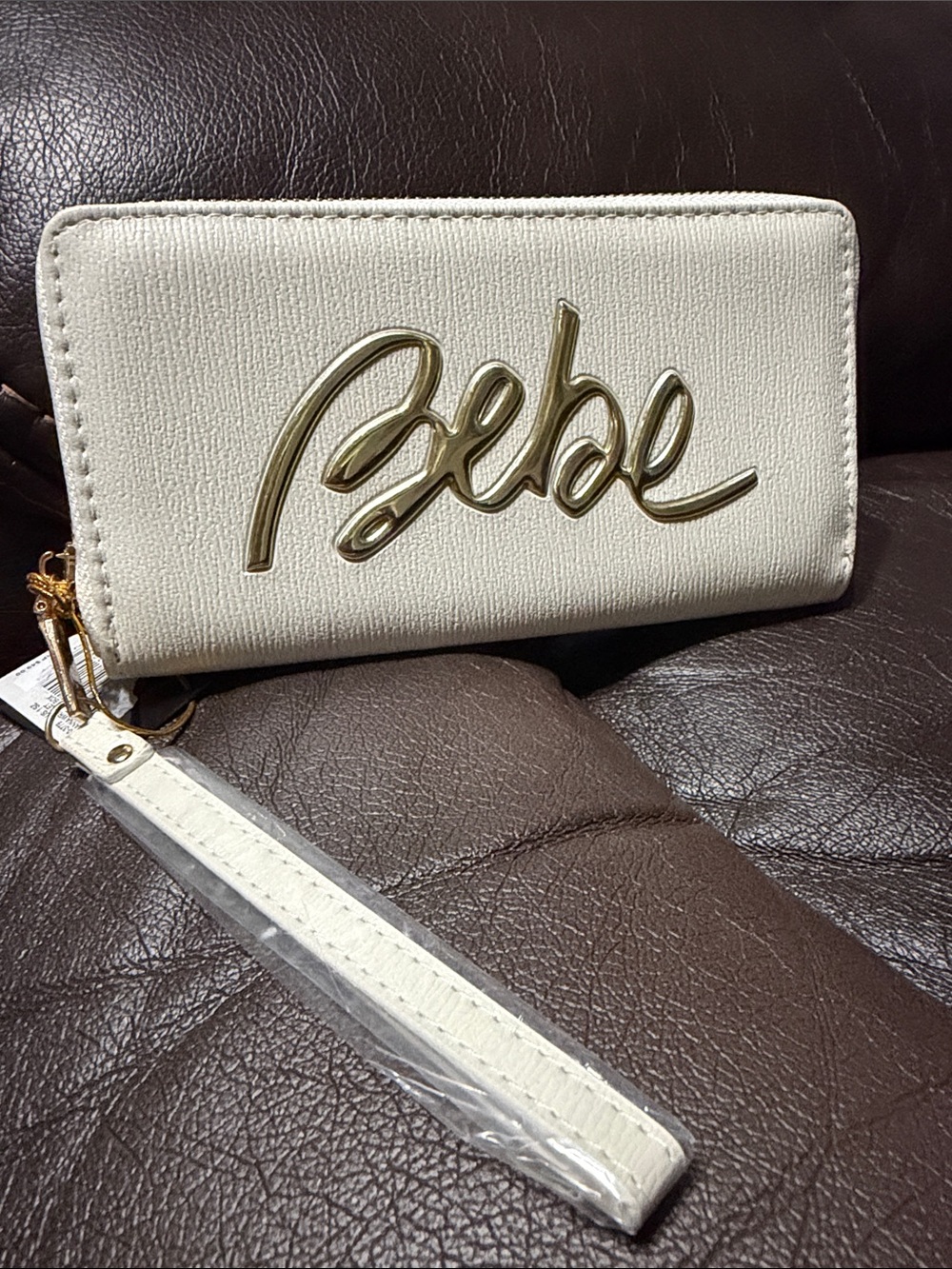 bebe Off-White Wristlet with Gold Logo